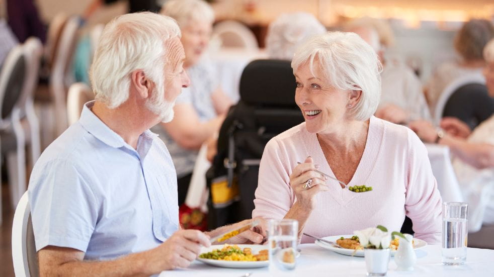 Retirement planning tips senior couple smiling having dinner
